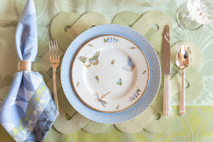 White dinner plate with cornflower blue lace border and hand-painted butterflies and flowers.