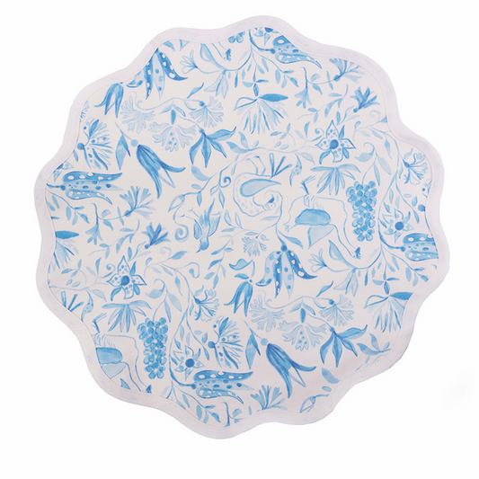 Round white placemat with scalloped edges featuring blue botanical and bird designs.