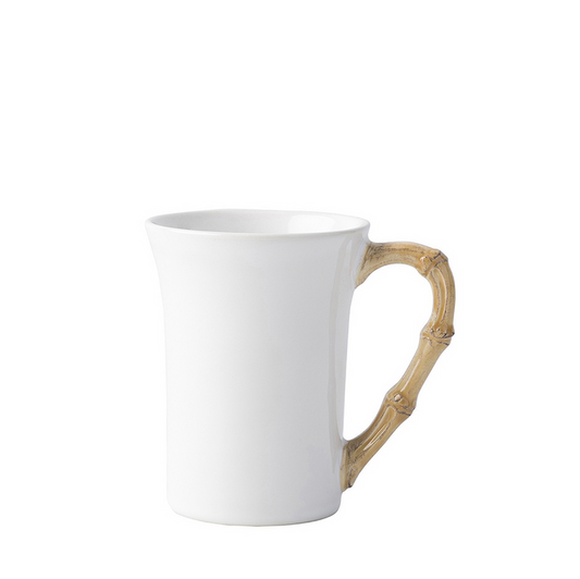 White ceramic mug with a natural bamboo-style handle and a slightly flared rim.