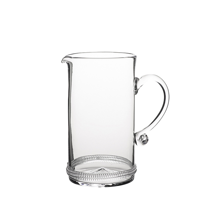 Clear glass pitcher with a round handle and textured base detailing.