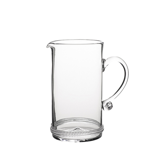 Clear glass pitcher with a round handle and textured base detailing.