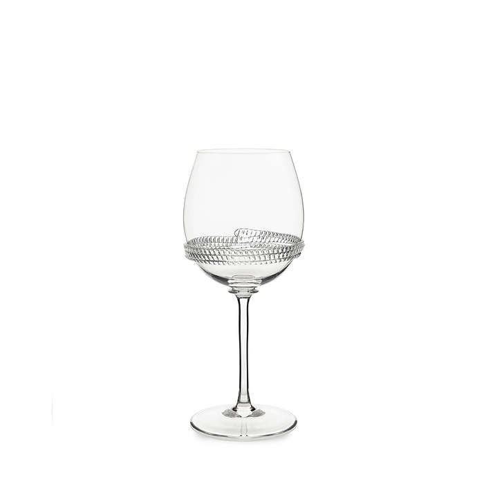 Clear wine glass with a textured dotted pattern around the bowl on a slender stem.