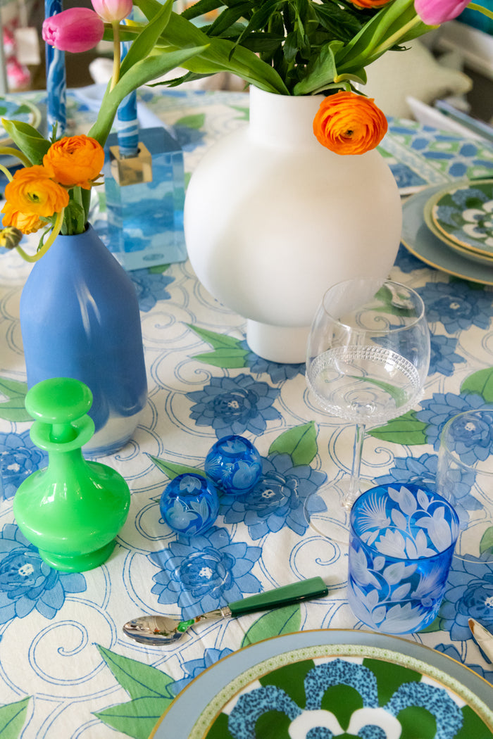 Clear Dean wine glass with elegant curved bowl on a floral blue and white tablecloth.