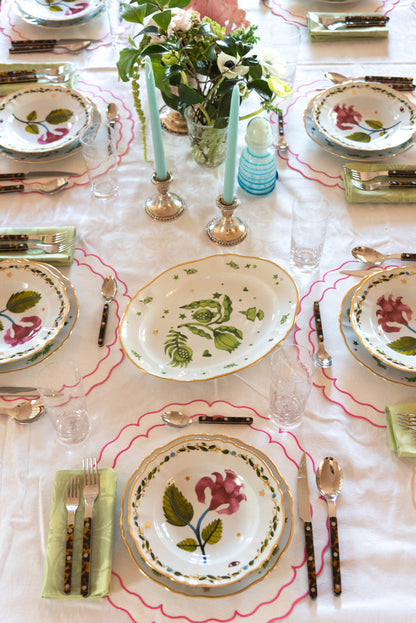 Pink Italiano Bloom deep plate with floral design and scalloped gold-trimmed edge.