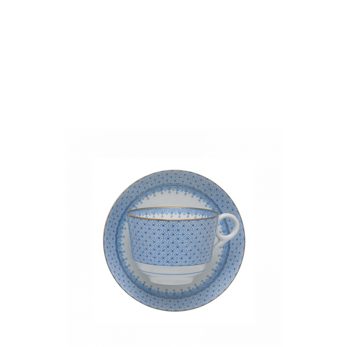 Cornflower blue lace-patterned ceramic cup with matching saucer on white background.