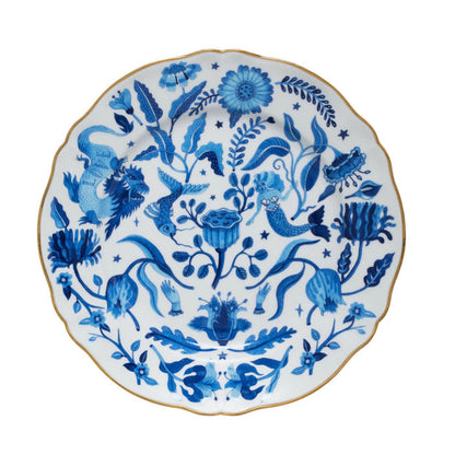 Round ceramic dinner plate with scalloped edges, decorated with intricate blue floral and bird patterns on white background, .