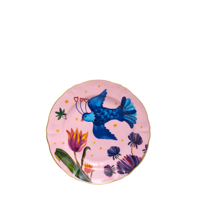Round pink dessert plate with gold rim, blue bird, and colorful floral design.