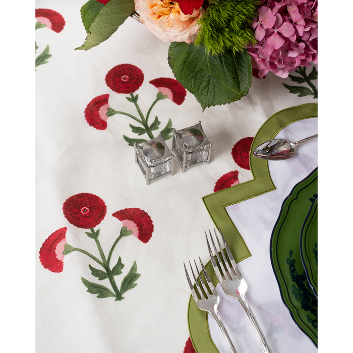 Platinum New York Diner salt and pepper shakers with clear glass bodies and silver tops on embroidered floral tablecloth.