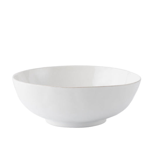 Whitewashed ceramic serving bowl with smooth, slightly textured matte finish and rounded edges.