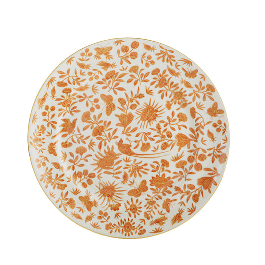 White dinner plate with intricate orange floral and butterfly pattern and gold rim.