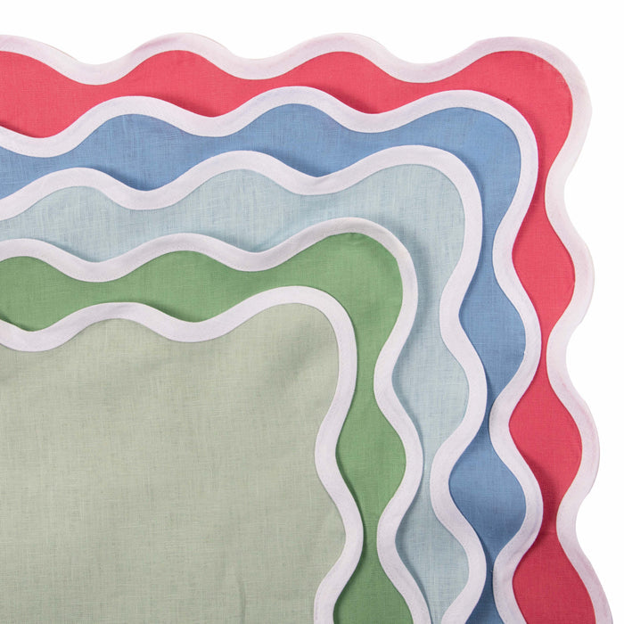 Stack of scalloped linen napkins in sky blue, green, and coral with white trim.