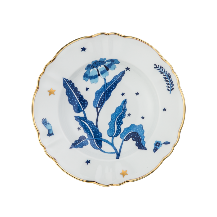 White deep plate with blue floral and star designs, scalloped gold-rimmed edge.
