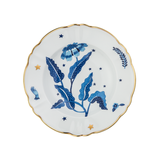 White deep plate with blue floral and star designs, scalloped gold-rimmed edge.