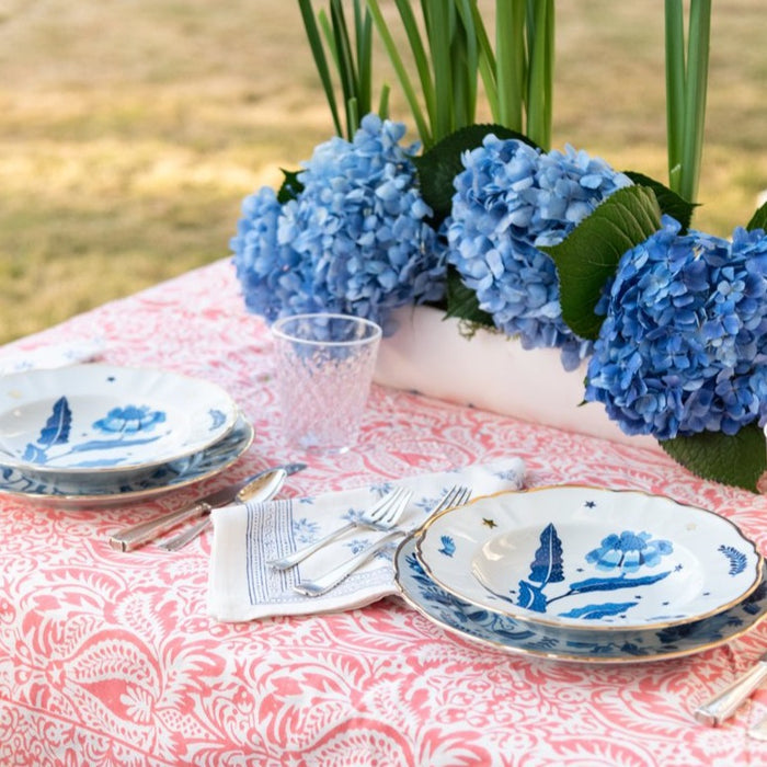 Blue ceramic deep plate with dark blue starry night pattern on white background.