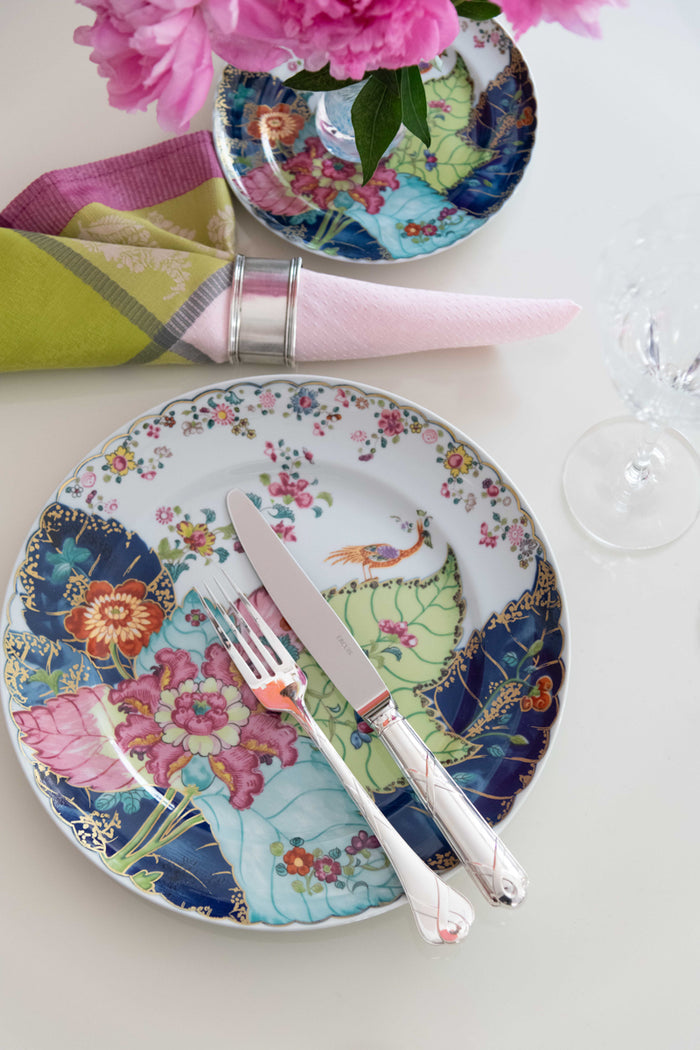 Round bread and butter plate with colorful floral and bird motifs on white background.