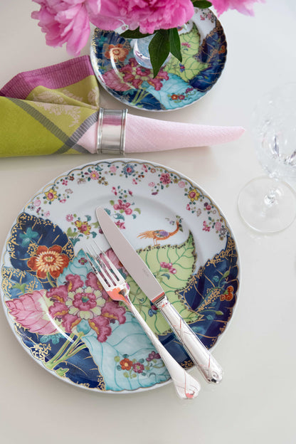 Round bread and butter plate with colorful floral and bird motifs on white background.
