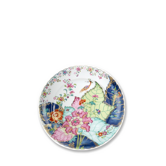 Round dessert plate with colorful tobacco leaf and floral pattern on white background.