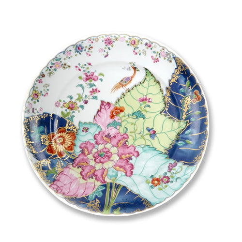White dinner plate with colorful floral and tobacco leaf design in pink, green, blue, and orange hues.